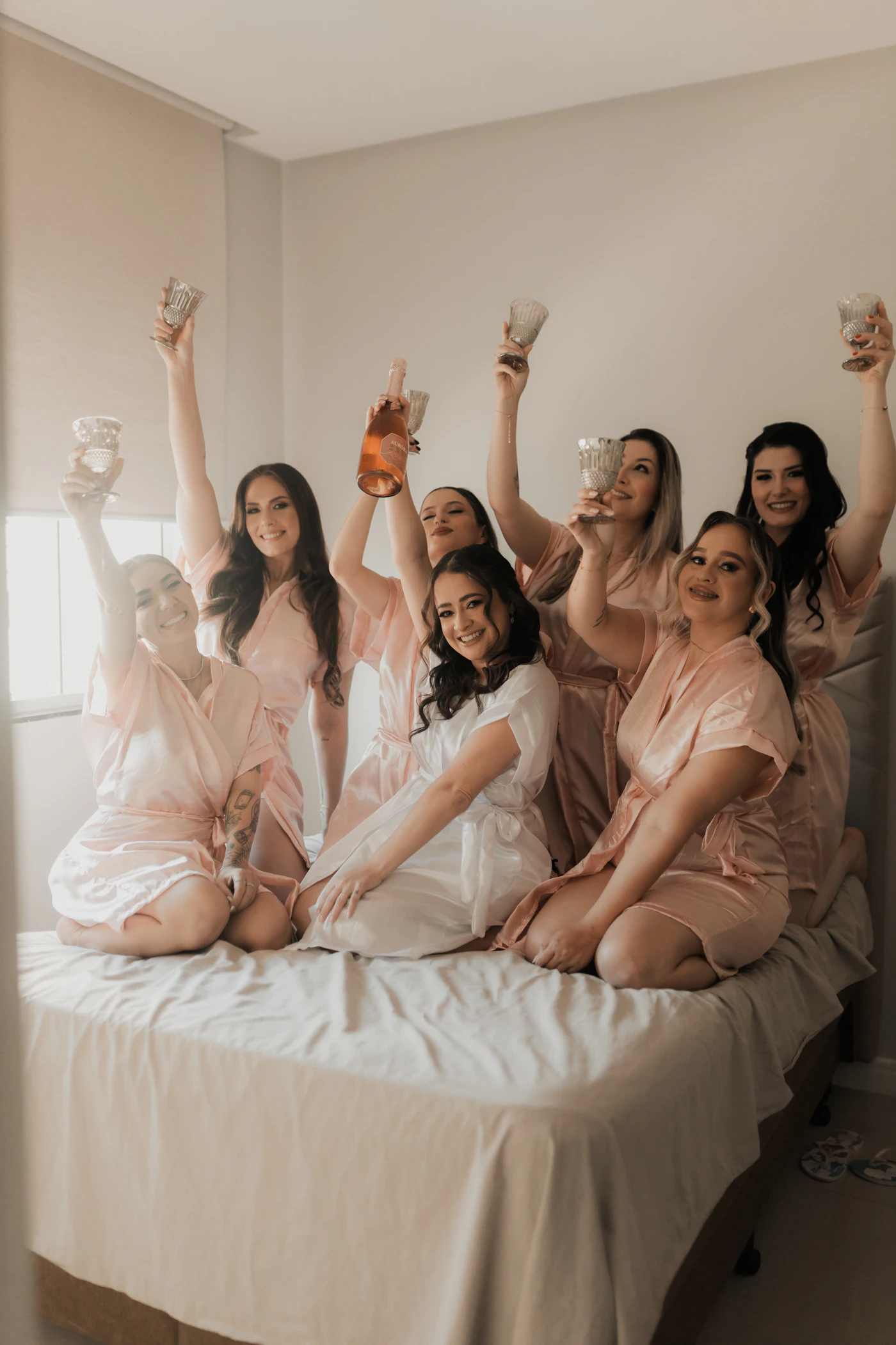 A bridal party in robes celebrating at a pamper party