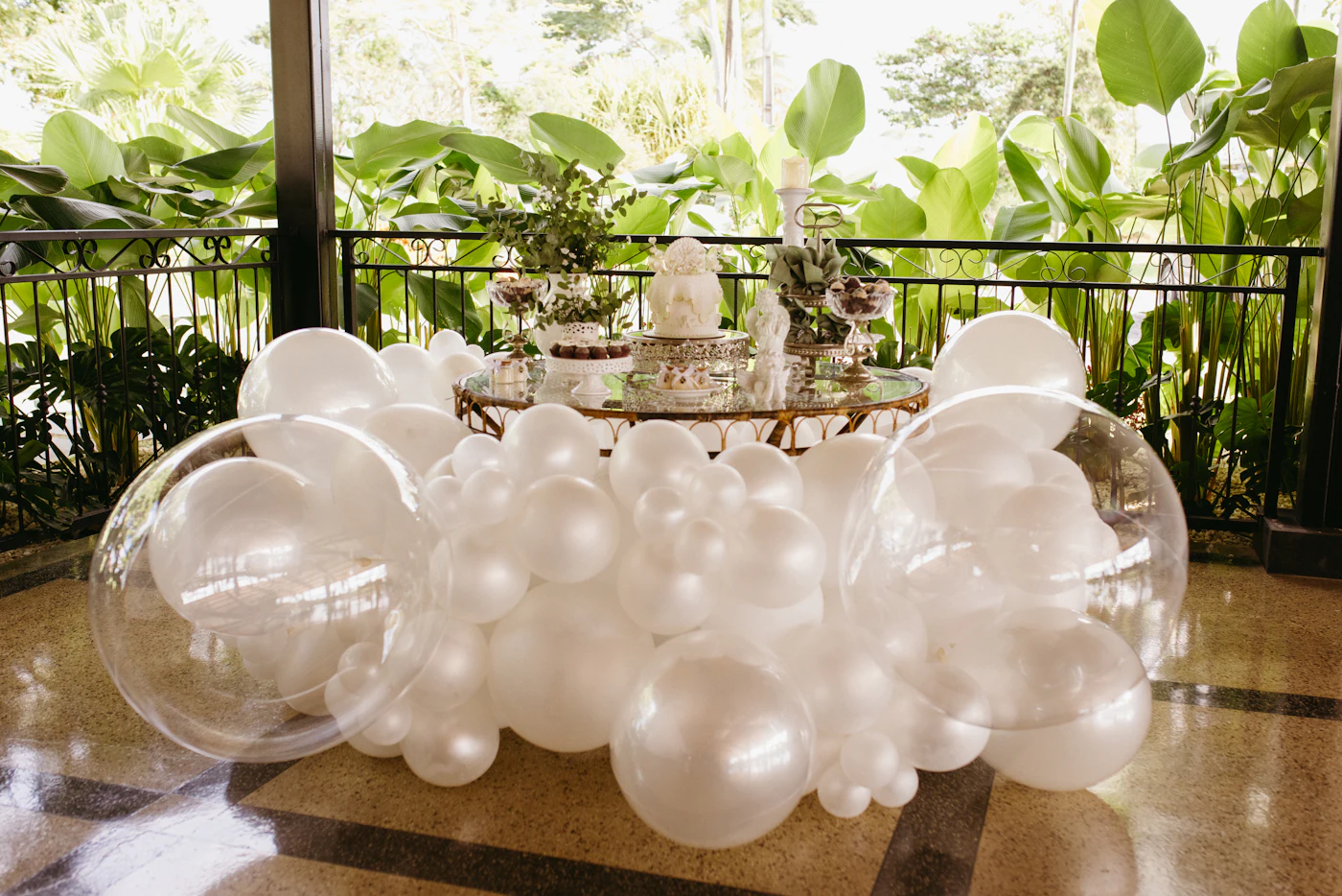 An elegant balloon and floral display styled for a celebration